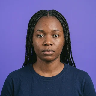Dana Okonkwo, photographed straight on against a violet backdrop.