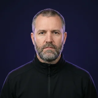 Marcus Feld, photographed straight on against an indigo backdrop.