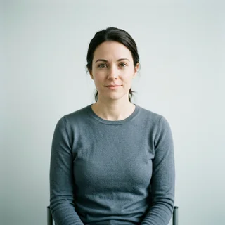 Priya Kanwal, photographed against a plain clinical backdrop.