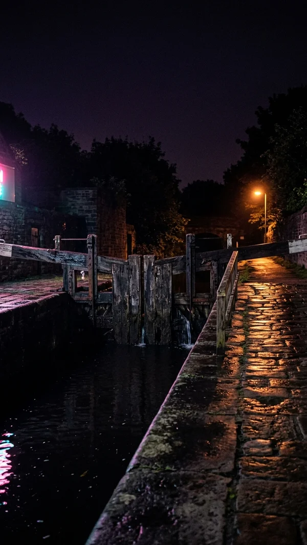 A canal lock gate at night
