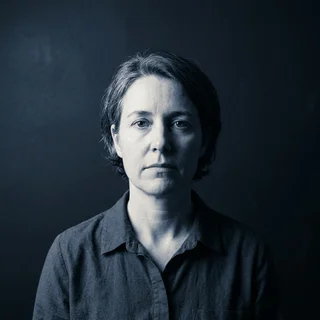 Dana Restrepo, photographed head-on under a single cold light.